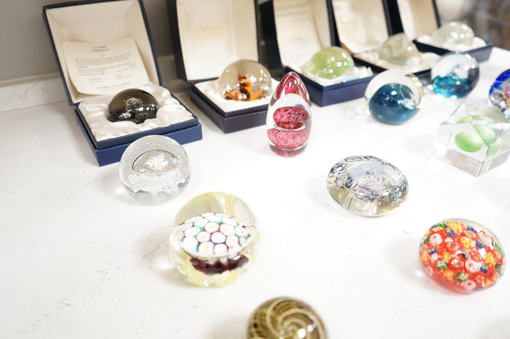 A collection of twenty seven glass paperweights some boxed, to include Caithness and Wedgwood, largest 12cm high. Condition - mostly good